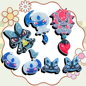 Some big action packed Poke necklaces, earrings, cute pin badges made from bio resin, Lucar, Abso, and Zoroa. Dark steel type