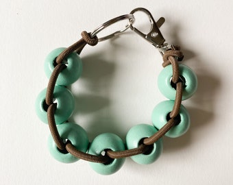 Bracelet élastique perlé/porte-clés