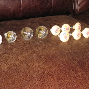 ASSORTMENT DRAWER KNOBS Six Beige Ceramic Round Knobs Floral Design Center One White Ceramic Pink Rose Center Three Glass Prism Knobs