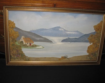 FABRIC COLLAGE On Painted Background Wood Frame 12 1/2" x 21 1/2" Mountains, Lake And Little House Not Covered In Glass On Masonite Board