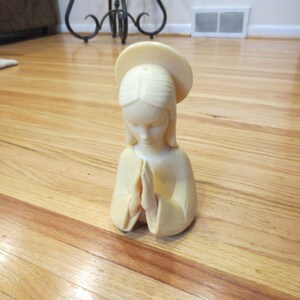 VIRGIN MARY PRAYING Celluloid Statue Of Mary Praying 7 1/2&quot; High, 4&quot; Across Bottom Beige Color Textured To Look Carved Religious Figure