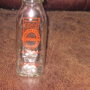 RONNYBROOK FARM DAIRY 1/2 Litre Dairy Bottle Ancramdale N.Y. Ronnybrook Story On Back Red Graphics On Clear Glass 7 1/4&quot; High Square Bottle