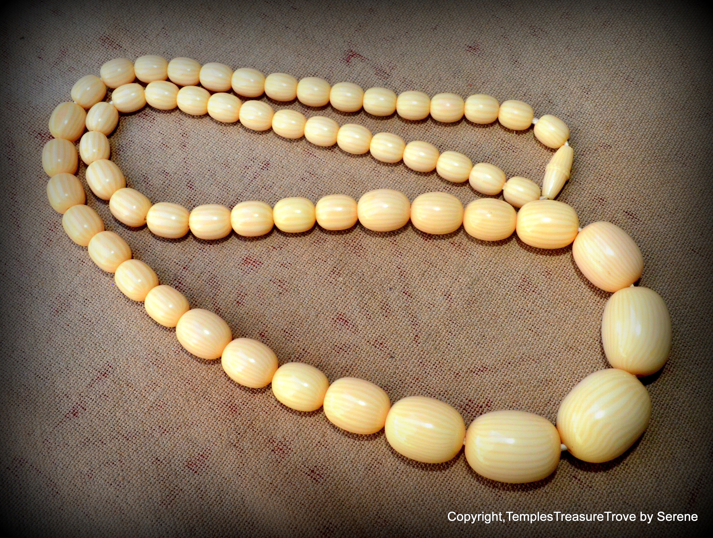 Carved ivory bead best sale necklace