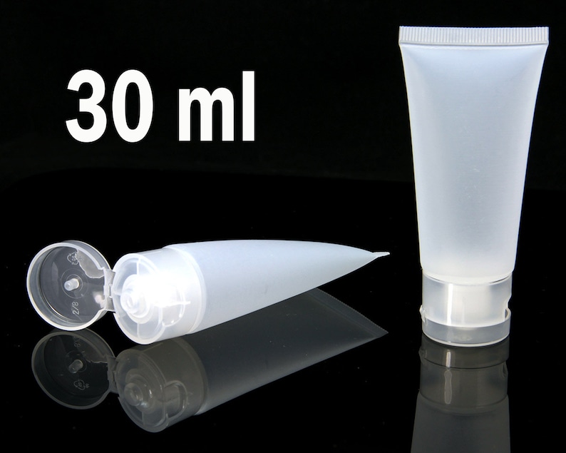 May include: Two clear plastic tubes with flip tops. One tube is lying down with the top open. The other tube is standing upright. Both tubes are labeled "30 ml".