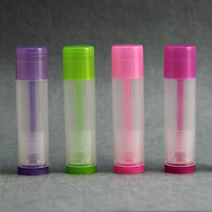 May include: Six clear plastic tubes with different colored caps. The caps are yellow, purple, green, pink, pink, and blue.