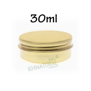 May include: A gold metal tin container with a screw-on lid. The container is 30 ml in size.