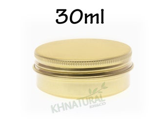 May include: A gold metal tin container with a screw-on lid. The container is 30 ml in size.