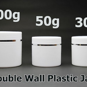 May include: Three white plastic jars with silver lids. The jars are labelled 100g, 50g, and 30g. Double Wall Plastic Jars.