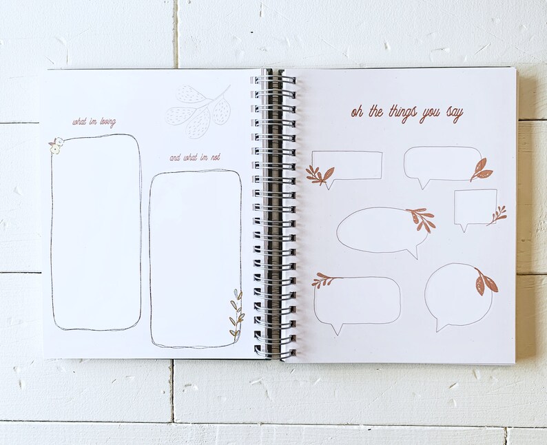 May include: A blank journal with a white cover and a spiral binding. The left page has the text "what I'm loving" and "and what I'm not" with blank spaces for writing. The right page has the text "oh the things you say" with several blank speech bubbles.