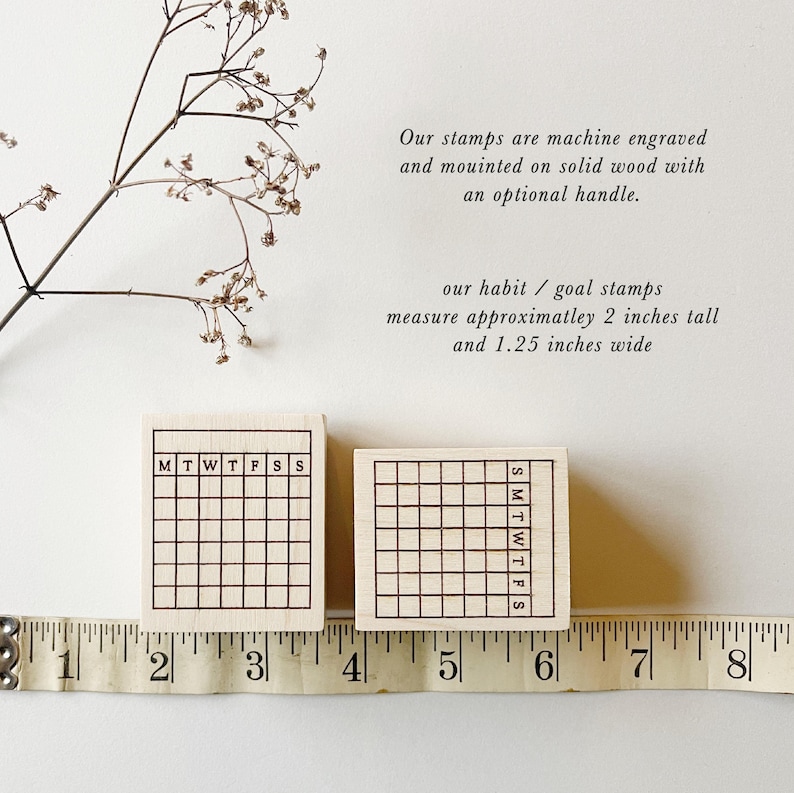 May include: Two wooden stamps with a grid pattern and the days of the week labeled. The stamps measure approximately 2 inches tall and 1.25 inches wide.  The stamps are shown next to a ruler.