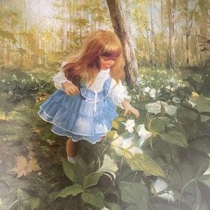 May include: A young girl in a blue dress with white lace trim stands in a forest, looking down at white flowers. The forest is lush and green, with tall trees and sunlight filtering through the leaves.