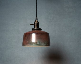 Angled Raku fired hanging pendant light in metallic pinkish with a flash of green