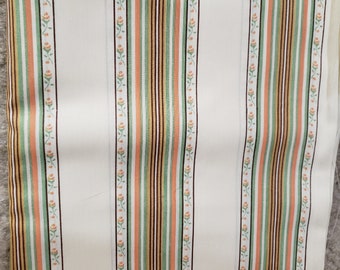 May include: White fabric with vertical stripes in shades of orange, green, brown, and gold. The stripes are thin and have a subtle floral pattern.