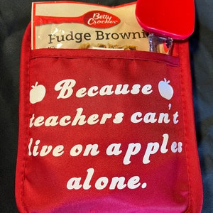 Red Silicon Pocket Pot Holder with Cookie Mix or Brownie Mix Inside and a Kitchen Utensil