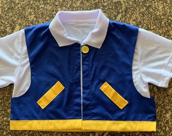 May include: A blue and yellow vest with a white collared shirt underneath. The vest has a yellow trim and two yellow pockets on the front. The shirt has short sleeves.