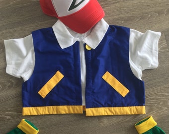 May include: A child's costume set featuring a red and white baseball cap with a green logo, a blue vest with yellow accents, a white shirt, and green gloves with yellow cuffs. The outfit is designed to resemble a popular cartoon character.