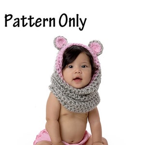 May include: A baby wearing a gray and pink crocheted hooded scarf with bear ears. The scarf is made with a chunky yarn and has a simple stitch pattern. The text "Pattern Only" is visible at the top of the image.