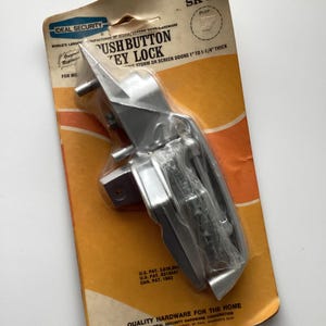 May include: A handmade wooden sign with the text "Welcome" in a playful font. The sign is painted white with a distressed finish, and features a decorative floral design. It measures approximately 12 inches wide and 6 inches tall.