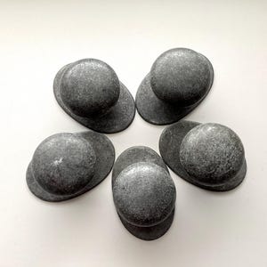 May include: A set of three ceramic mugs with a speckled, matte finish in cream, light grey, and dark grey. Each mug has a minimalist design, ideal for tea or coffee.