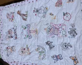 Embroidered handmade baby blanket with a sampler of designs 40 x 32