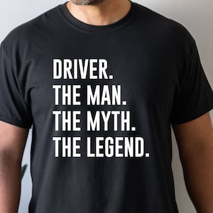 May include: A black t-shirt with white text that reads "DRIVER. THE MAN. THE MYTH. THE LEGEND."