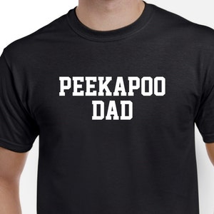 May include: Black t-shirt with white text that reads "PEEKAPOO DAD".