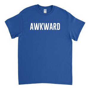 May include: A royal blue t-shirt with the word "AWKWARD" printed in white on the front.