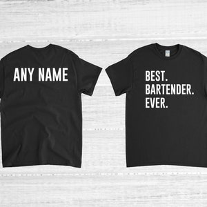 May include: Two black t-shirts. One shirt has the text "ANY NAME" in white block letters. The other shirt has the text "BEST. BARTENDER. EVER." in white block letters. Both shirts have short sleeves and a crew neck.