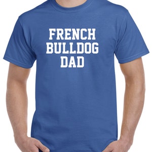 May include: A royal blue t-shirt with white text that reads "French Bulldog Dad".