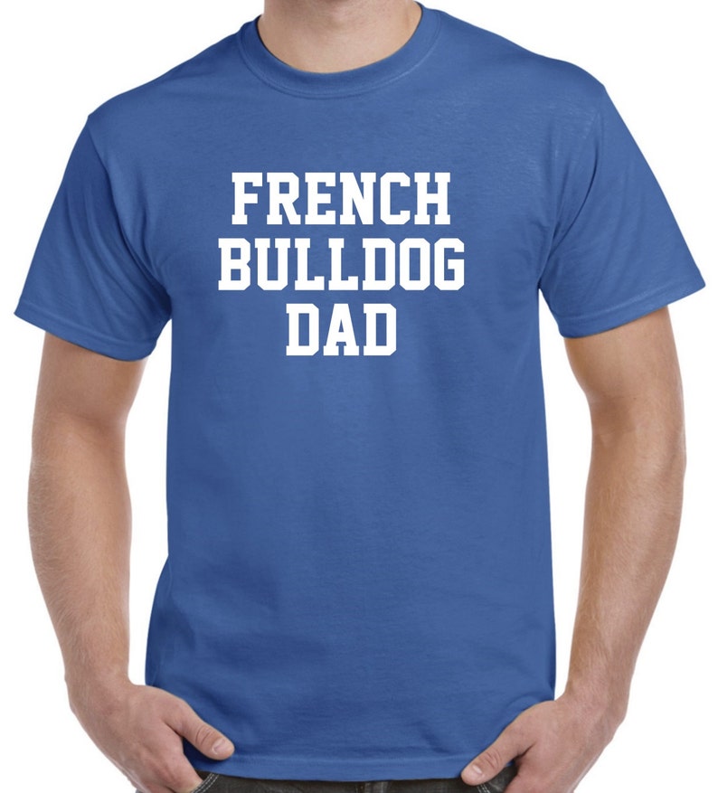 May include: A royal blue t-shirt with white text that reads "French Bulldog Dad".