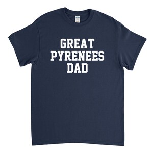 Op de afbeelding: Donkerblauw T-shirt met witte tekst die "Great Pyrenees Dad" zegt.