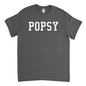 May include: A charcoal gray t-shirt with the word "POPSY" printed in white on the front.