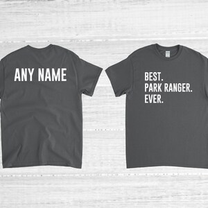 May include: Two dark gray t-shirts with white text. The front of one shirt says "BEST. PARK RANGER. EVER." The back of the other shirt says "ANY NAME".