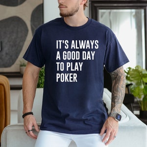 May include: A navy blue t-shirt with white text that reads "It's always a good day to play poker."