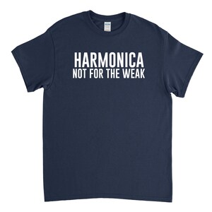 May include: A navy blue t-shirt with white text that reads "Harmonica Not For The Weak".