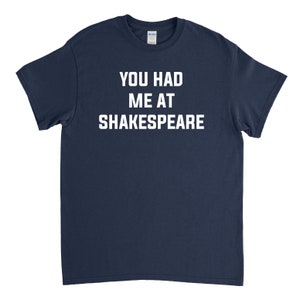 May include: A navy blue t-shirt with white text that reads "You had me at Shakespeare."