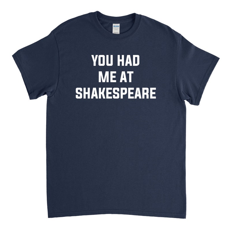 May include: A navy blue t-shirt with white text that reads "You had me at Shakespeare."