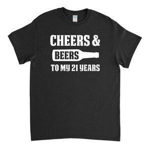 May include: Black t-shirt with white text that reads "Cheers & Beers to my 21 years" and a white silhouette of a beer bottle.