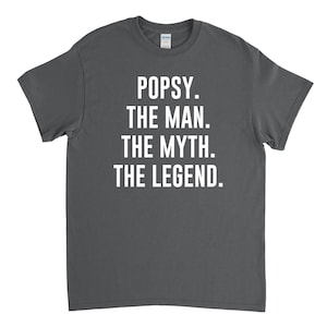 May include: Dark gray t-shirt with white text that reads "Popsy. The Man. The Myth. The Legend."