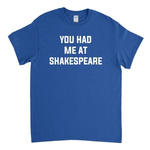May include: A royal blue t-shirt with white text that reads "You had me at Shakespeare."