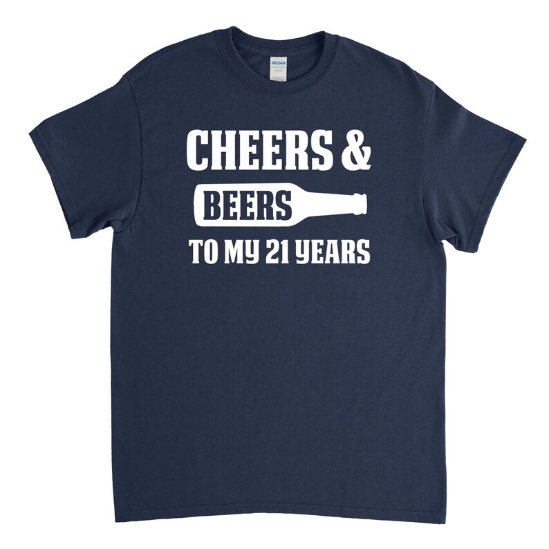 May include: Navy blue t-shirt with white text that reads "Cheers & Beers to my 21 years" and a white silhouette of a beer bottle.