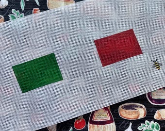 May include: White canvas with green and red squares, resembling the Italian flag, on a black background with a pattern of tomatoes, garlic, olive branches, and Italian-themed text.