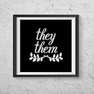 May include: Black and white framed print with the text "they them" in a cursive font with a small wreath of leaves below the text.