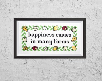 May include: A framed cross-stitch design with a white background and green leaves surrounding various cheese shapes. The text reads "happiness comes in many forms".