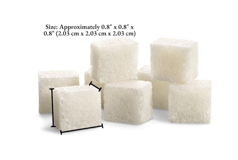 An image of several sugar cubes, showing the dimensions of Meliora Forever cocktail cubes. The dimensions are 0.8 inches (2.03 centimeters) cubed - length, width, and height.