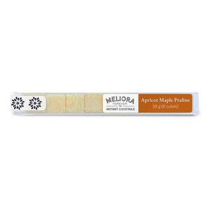 May include: A clear plastic tube containing eight apricot maple praline cubes. The tube has a white label with the text "MELIORA FOREVER INSTANT COCKTAILS" and an orange label with the text "Apricot Maple Praline 38 g (8 cubes)".