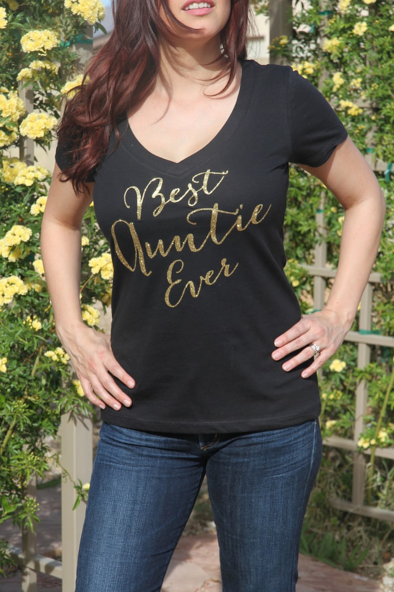 May include: Black v-neck t-shirt with gold glitter lettering that reads "Best Auntie Ever".