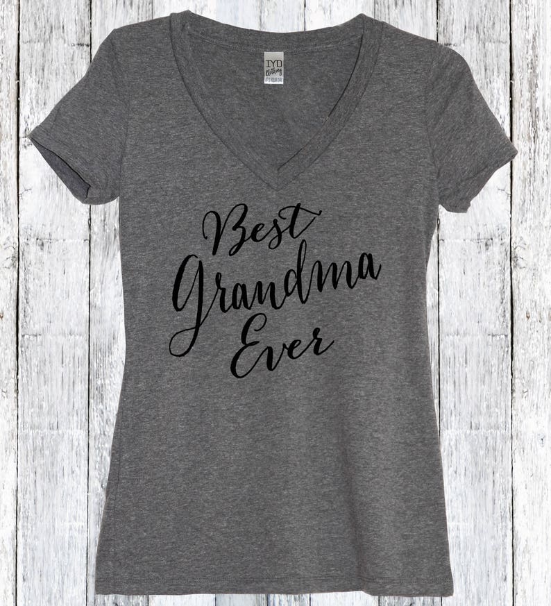 May include: Gray V-neck t-shirt with the text "Best Grandma Ever" in black cursive lettering.