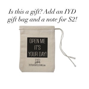 May include: A white cotton drawstring bag with black text that reads "Open Me It's Your Day!" and the logo "TYD Clothing ItsYourDayClothing.com".