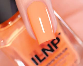 May include: Close-up of a fingernail painted with bright orange nail polish. The polish is glossy and reflects light, with the brand name "ILNP" visible on the bottle. The overall theme is beauty and nail care.